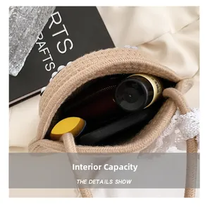 Detail showing internal capacity of straw woven round bag with pearl trim decor