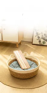 Detail of hand-woven cat bed with cooling mat and seigaiha pattern cushion in home setting