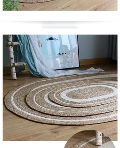 Detail of oval woven jute rugs in various sizes with natural and white striped patterns
