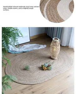 Close-up of the natural handmade woven texture and striped design of the oval straw rug