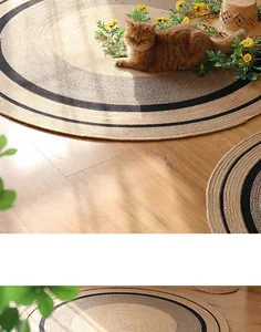 Detailed top view of a handwoven jute rug with circular black stripes on wooden floor
