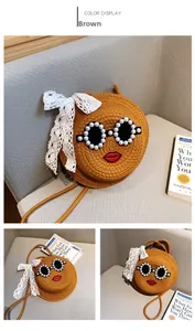 Detail of a brown woven straw crossbody bag with pearl sunglasses and a large lace bow