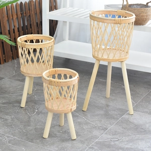 Three-piece set of Nordic rattan planters with wooden tripod legs for indoor plants