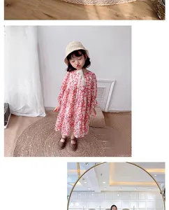 Detail of floral girl's dress with pink patterns on a Nordic woven straw rug surface