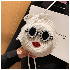 Detail of white woven bag with pearl sunglasses, red lip embroidery and lace bow