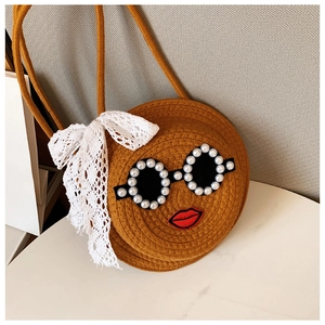 Detail of round straw crossbody bag with pearl sunglasses design and lace bow accent