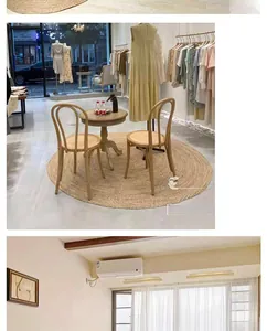 Detail of round woven seagrass rug under wooden furniture in minimalist boutique