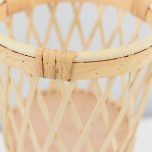 Detailed macro view of handcrafted diamond weave texture on a natural rattan flower basket