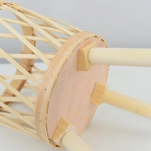 Detail of hand-woven rattan planter base with solid wood legs and diamond pattern