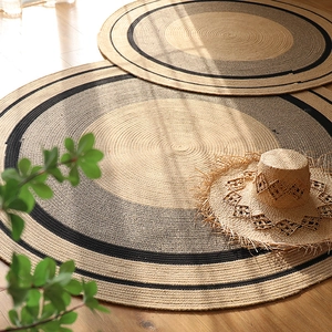 Handwoven round cotton jute rug with black spiral stripes for minimalist home decor