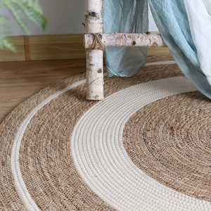 Oval handwoven jute area rug with spiral white and natural tones for bohemian home decor