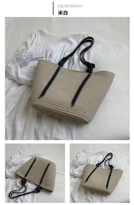 Detailed macro view of beige woven tote bag with premium leather straps and fine texture
