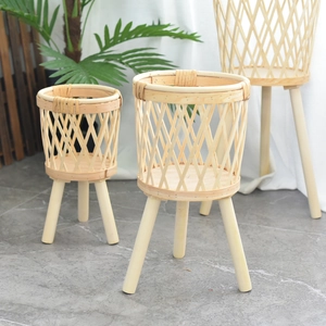 Three-tier woven bamboo plant stands with wooden legs in a Nordic minimalist setting