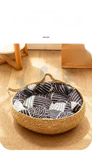 Handwoven rattan cat bed with a wave-patterned removable cushion and side handles