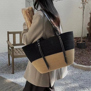 Chic woven cotton bucket bag featuring a black and khaki two-tone design with leather straps