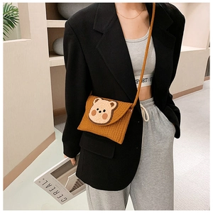 Detail of the brown corduroy texture and 3D bear patch on this mini bohemian crossbody bag