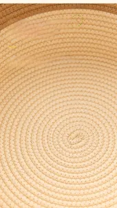 Macro shot of the spiral sewing texture on the natural cotton rope woven cat bed
