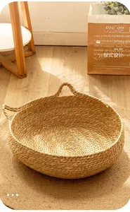 Detail of round woven seagrass cat bed with integrated handles and a matching mat