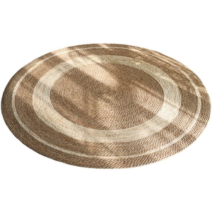 Nordic handmade round jute rug with concentric brown and cream stripes in sunlight
