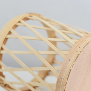 Nordic handwoven rattan plant stand with wooden legs and natural bamboo texture