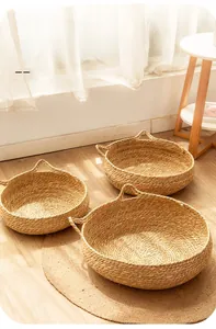 Detailed view of natural woven grass pet beds in three sizes with cute cat ear handles