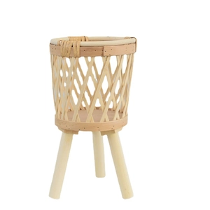 Nordic woven rattan flower stand with three wooden legs and natural mesh basket