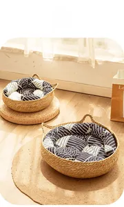 Handwoven straw cat beds with geometric cushions in a sunny home interior setting