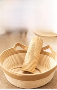 Detail of woven cotton rope pet bed and matching mat with minimalist cat ear design
