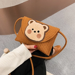 Bohemian woven straw envelope bag featuring a cute bear patch for beach vacation style