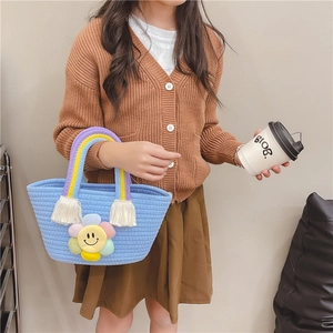 Kids handwoven cotton rope handbag featuring rainbow handles and colorful sunflower patch
