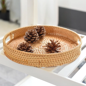 Handcrafted round rattan fruit basket with handles and natural woven texture
