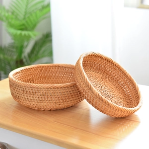 Close-up of two handmade round rattan storage baskets with natural woven texture
