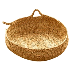Oval woven cattail pet bed for cats and small dogs with natural handles and rustic texture