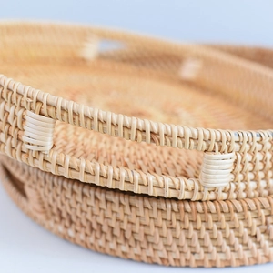 Detail of handcrafted rattan fruit basket featuring sturdy handles and woven texture