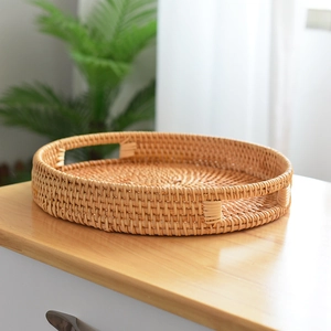 Handmade woven rattan fruit basket with handles and natural rustic finish for home decor