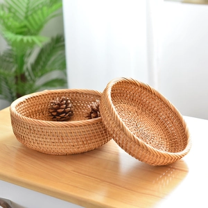 Handcrafted round rattan storage baskets for fruit and bread in a cozy home setting