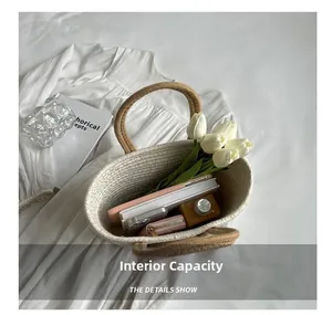 Internal capacity of the beige woven tote bag with a pink phone, notebook, and wallet