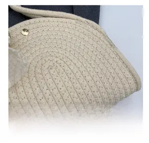 Detail of cream woven cotton fabric with delicate white lace trim and gold magnetic clasp