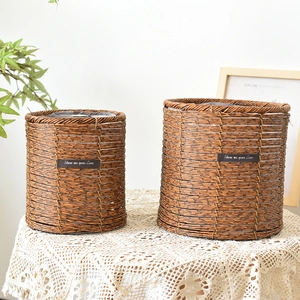 Close-up of handmade brown wicker baskets with waterproof liners and leather labels