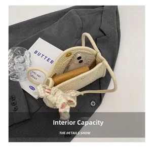 Close-up of cotton rope shoulder bag showing internal capacity for phone and wallet