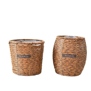Handwoven straw planters in dark brown with waterproof lining and leather logo detail