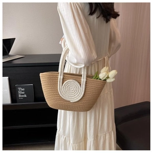 Detail of hand-woven cotton tote bag featuring two-tone texture and round patch detail
