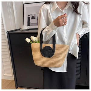 Detailed macro of woven tote bag with contrast black handles and round pattern
