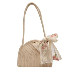 Chic beige woven cotton shoulder bag featuring a large embroidered floral bow decoration