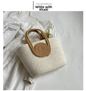 Detailed close-up of woven tote bag in white and khaki on a white summer dress