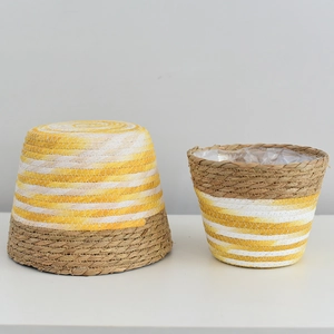 Set of 2 tapered hand-woven straw planters with yellow white stripes and waterproof liner