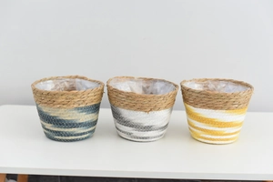 Detailed close-up of handmade woven plant baskets with waterproof lining and painted design