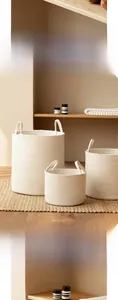 Detail of the thick cotton rope weaving texture and sturdy handles on Nordic storage baskets