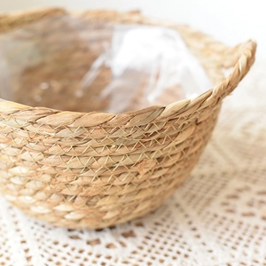 Handwoven seagrass plant basket with dual handles and waterproof liner for home decor