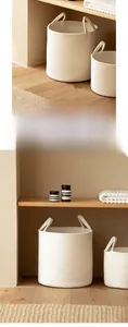 Detail of reinforced cotton rope handles and thick woven texture of the laundry basket